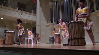 Elon students, who performed in Ghana during a winter term study abroad trip, drum onstage in Whitley for their final performance as a group.