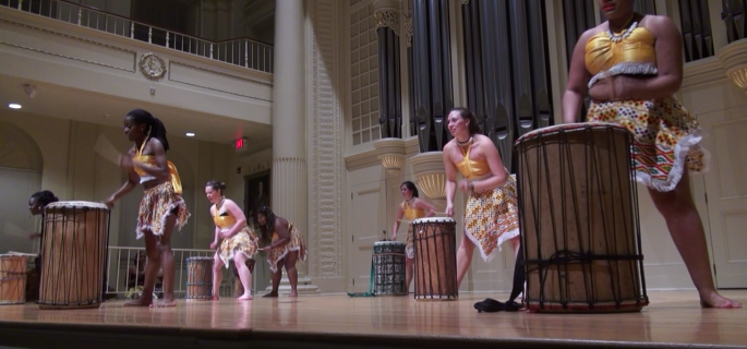 Elon students, who performed in Ghana during a winter term study abroad trip, drum onstage in Whitley for their final performance as a group.