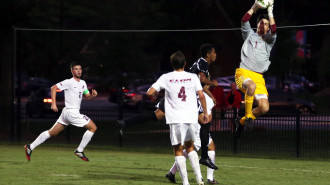 Elon Keeper Matthew Jegier makes a save in a game against Davidson. (Andrew Feather/ELN)
