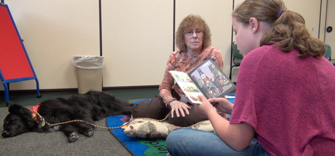 Burlington resident Kathleen Johns and Shaka, a registered therapy dog, volunteer each month with "Paws for Reading" in order to help kids with reading and self-confidence.